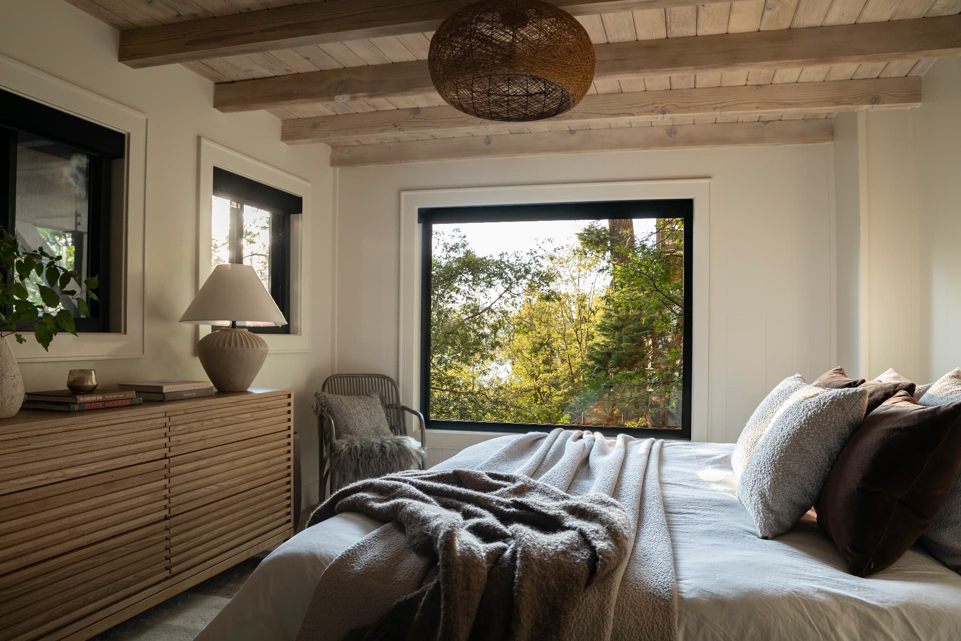 Guest bedroom with a window into the trees