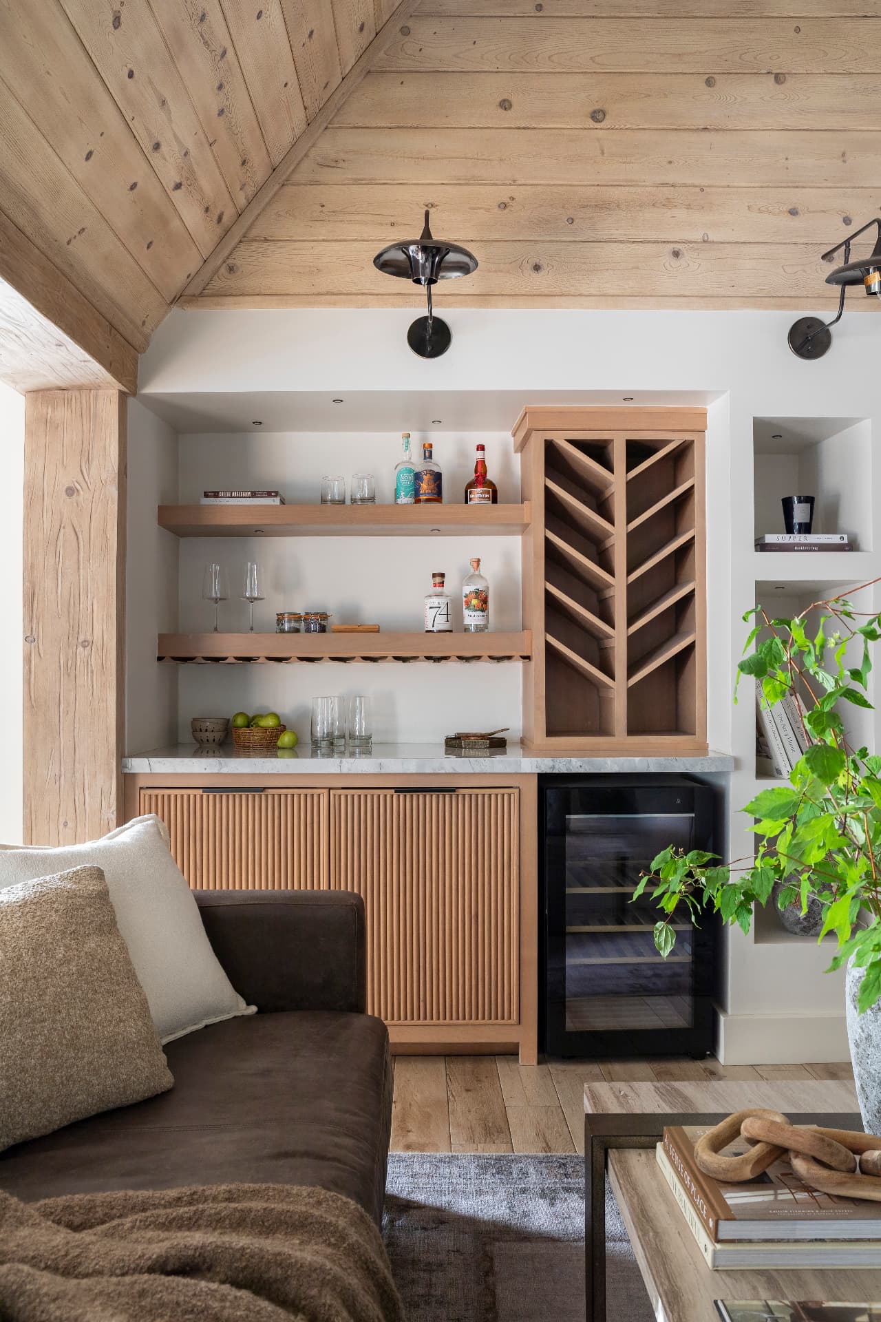 Built-in bar with fluted cabinetry and wine storage